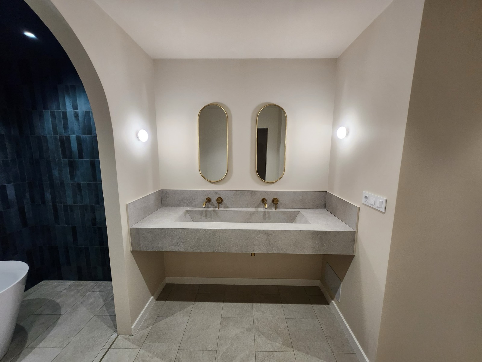 Floating stone washbasin for two with brass taps and twin oval mirrors