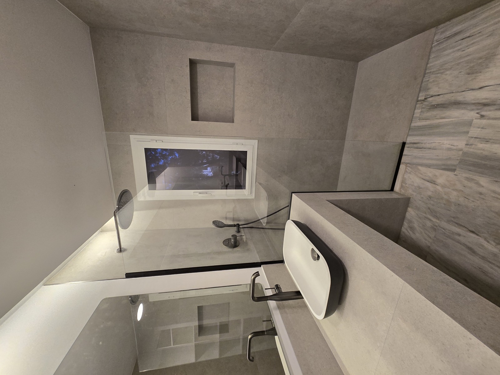Walk-in shower behind frameless glass