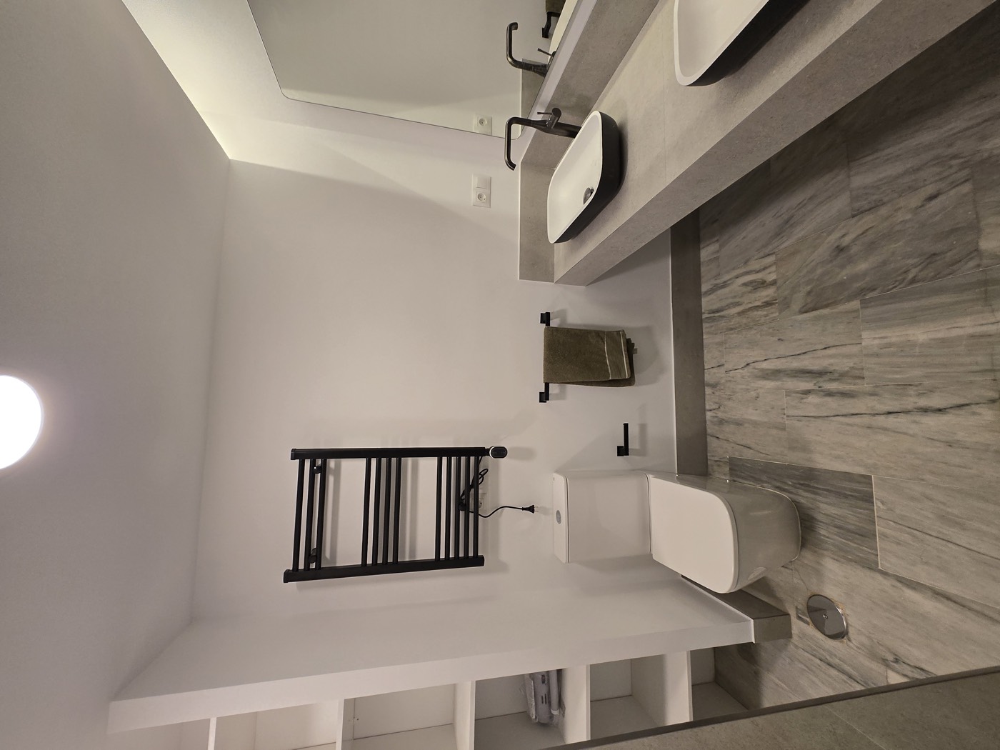 Finished bathroom with WC, towel radiator and shelving