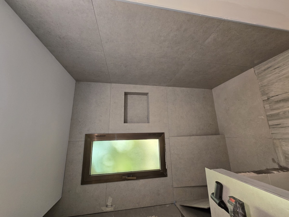 During: walls tiled and shower niche formed